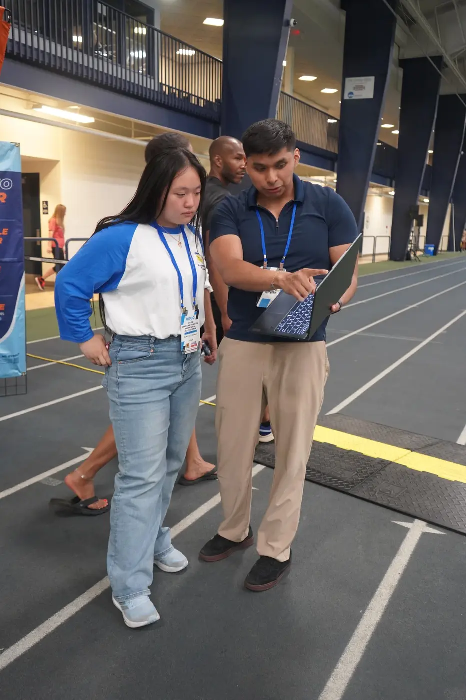 An AI Future coach reviewing a robot run with a student at the American Robotics Open Championship