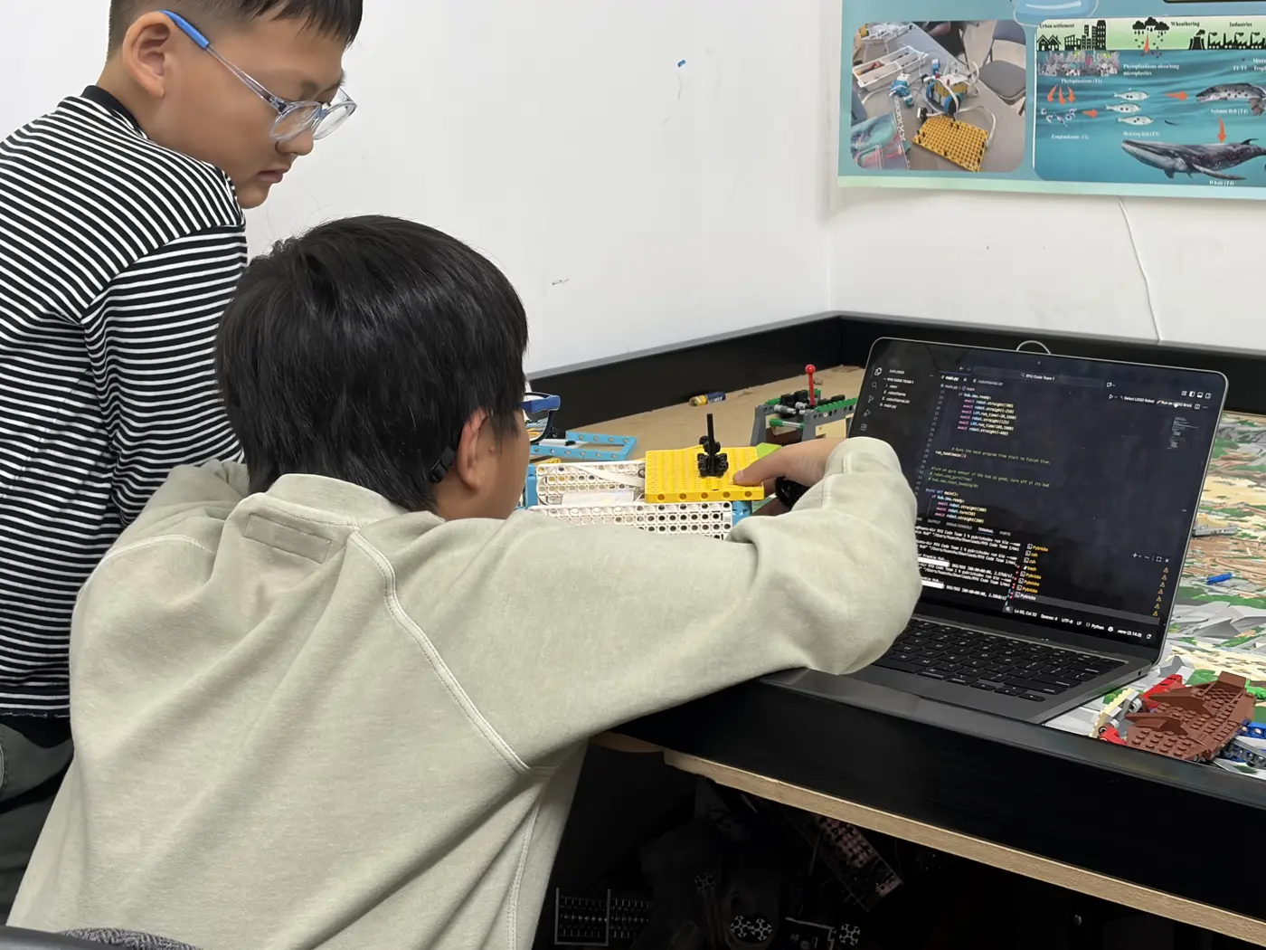 Coach and student coding an FLL robot