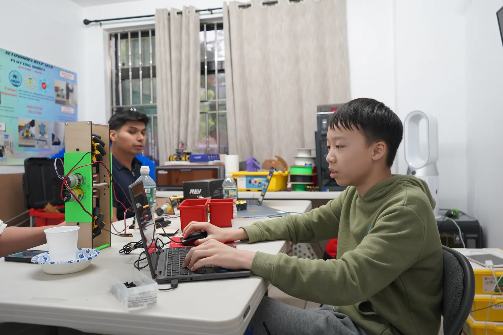 AI Future student coding and testing a robot project