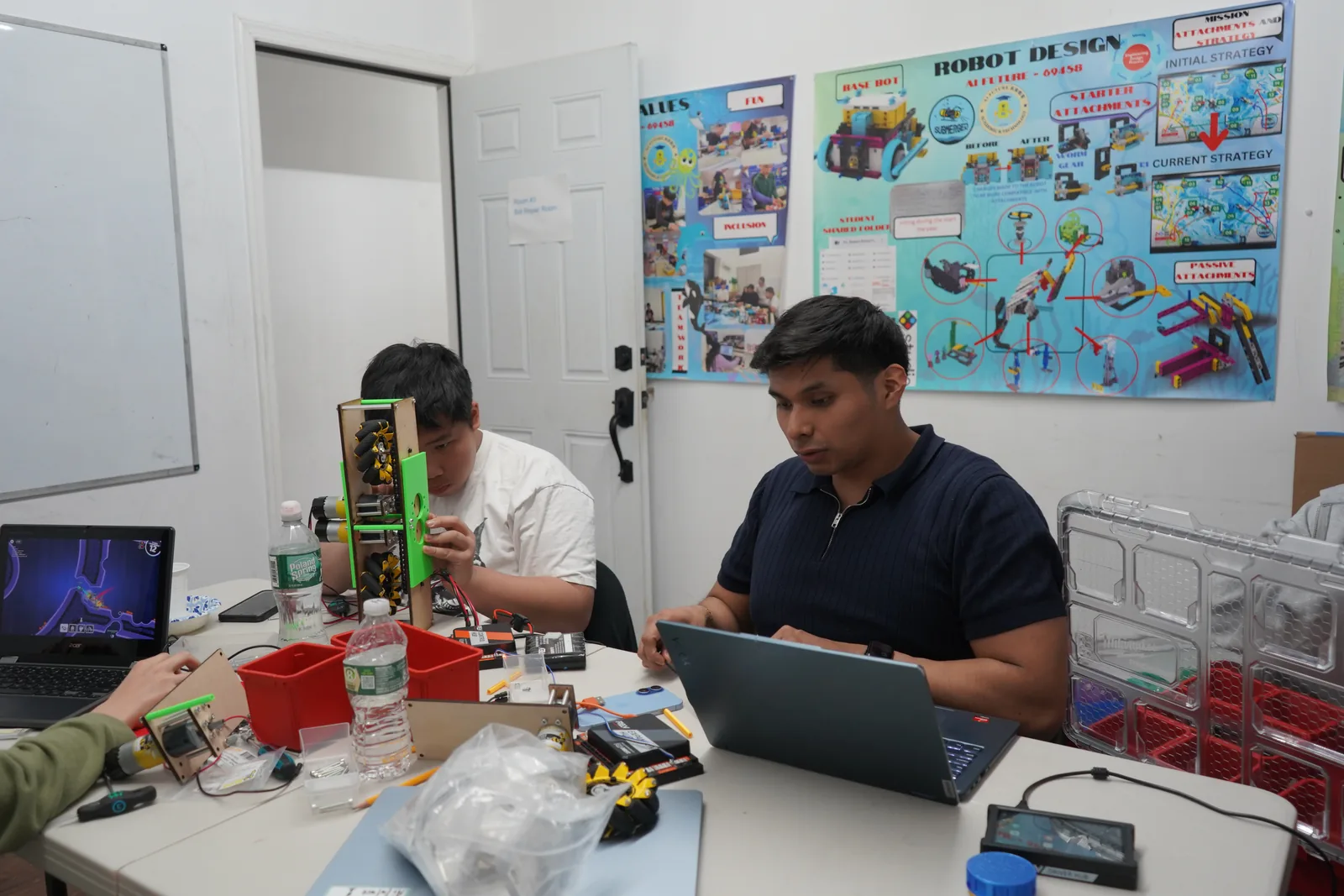 AI Future instructor supporting students during a robotics project build