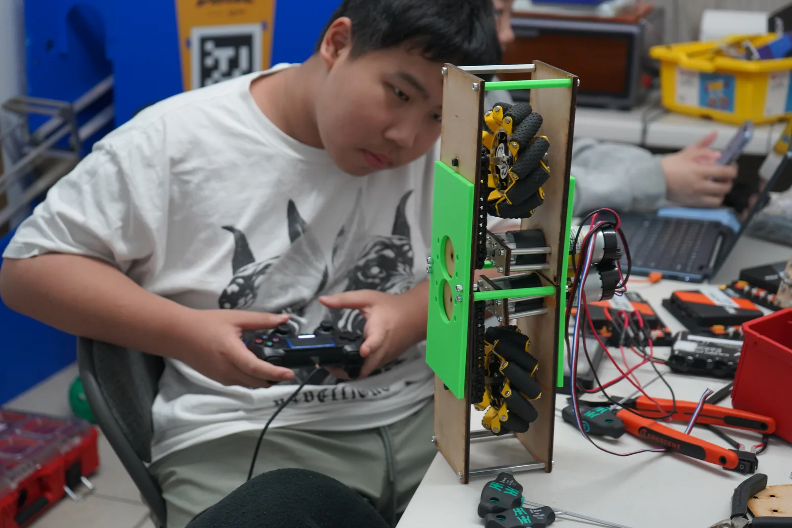 AI Future student focusing while controlling a robotics project